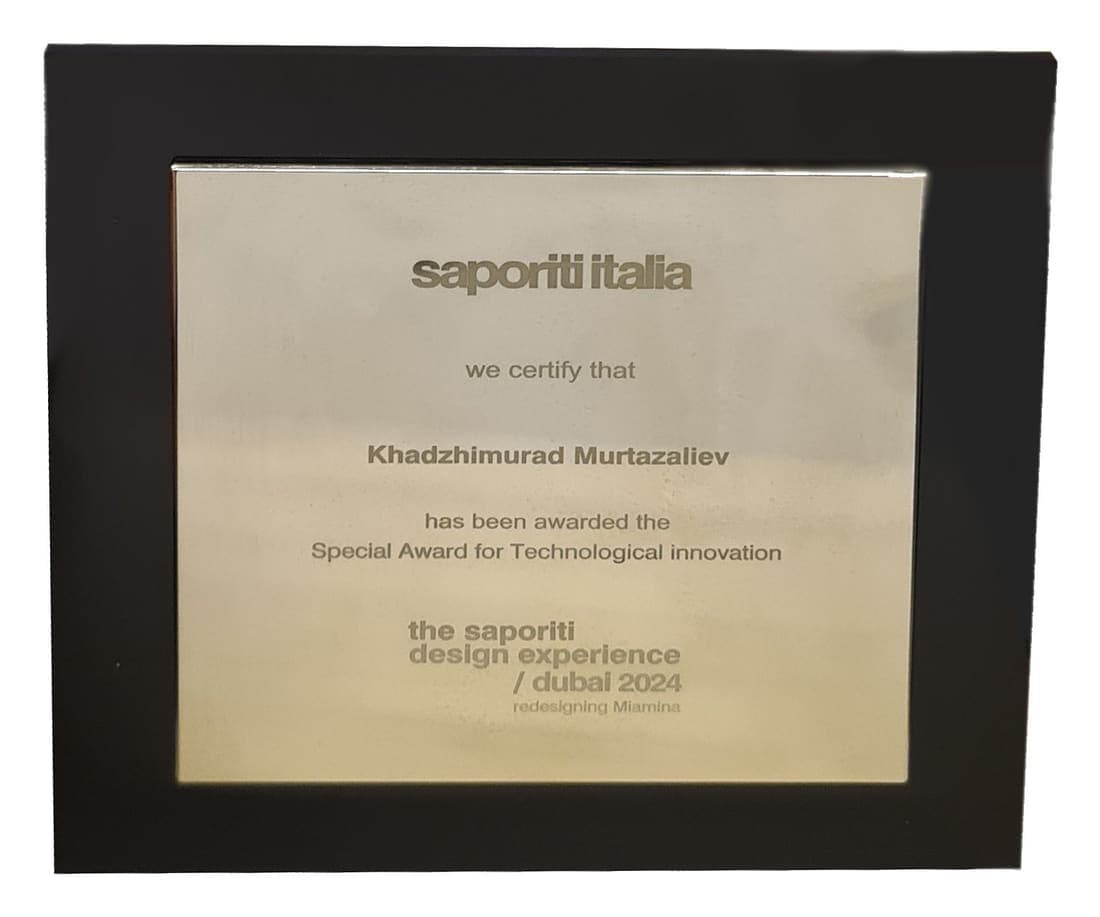 A brass plate in a black frame, engraved: saporiti italia, we certify that Khadzhimurad Murtazaliev has been awarded the Special Award for Technological Innovation, the saporiti design experience, dubai 2024, redesigning Miamina.